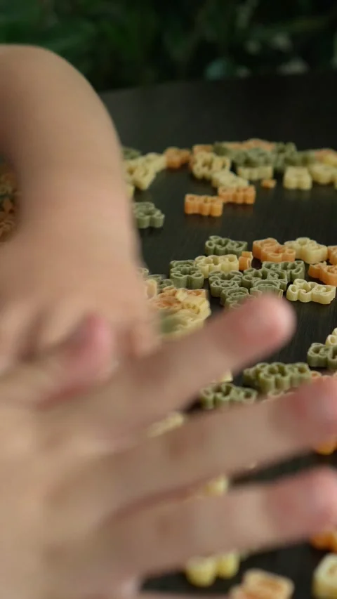 A child plays with teddy bear paste Stock Footage 317917729