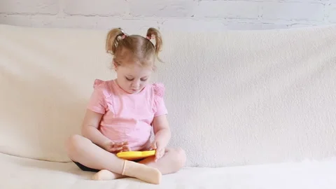 A child plays with a toy Stock Footage 155198462