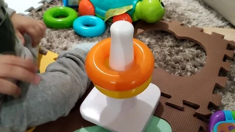 A child plays with a toy. Stockbeeldmateriaal 234645790