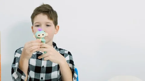 The child plays with a toy monkey Stock Footage 102652017