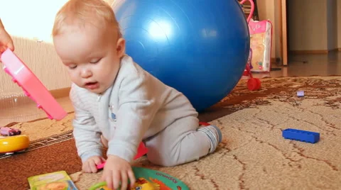 A child plays with toys Stock Footage 46971136