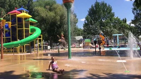 Child plays at water park, splash pad HD Stock-Footage 80237613