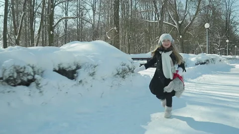 Child plays in the winter Park Stock Footage 87843235