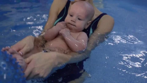 The child in the pool with the coach Stock Footage 82929536