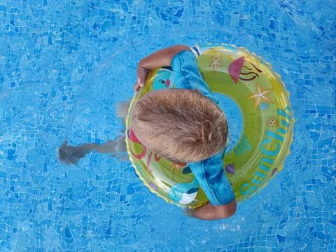 Child in the pool with an inflatable ring Stock Photos
