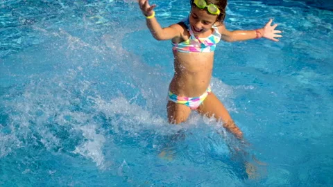 A child in the pool splashes water. Selective focus. Stock Footage 165058149