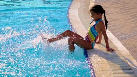 A child in the pool splashes water. Selective focus. Stock Footage 167073736
