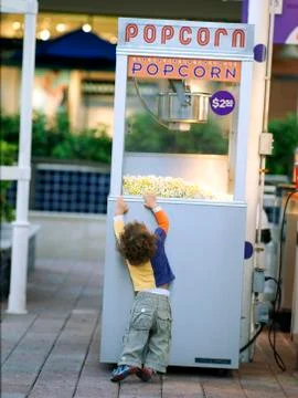 Child &amp; pop corn Stock Photos