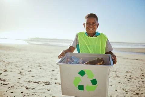Child, portrait and recycling, clean beach with box and plastic bottle Stock Photos