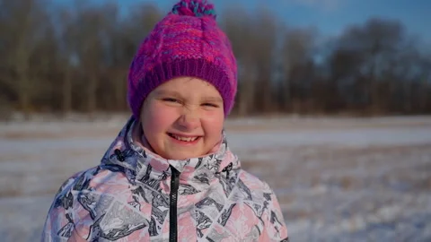 Child portrait looking at camera in winter outdoors. Forest on background Stock Footage 166585282