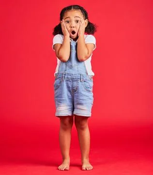 Child portrait, shocked or hands on face by isolated red background in kids Stock Photos
