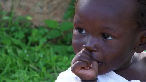 Child portrait Uganda EXT 2 thumb sucking Stock Footage 133912259