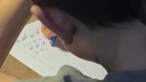 Child Practicing Lowercase a Close Up, Concept of Concentration and Skill Video stock 326633600