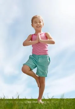 Child practicing yoga Stock Photos