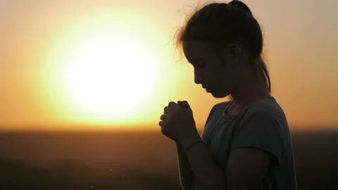 Child praying at sunset, thank God. Silh... | Stock Video | Pond5