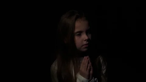 The child prays in a dark Video stock 85435951
