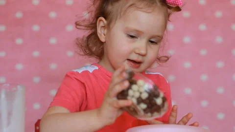 A child prepares breakfast for himself cereal with yogurt. Baby girl and eats Stock Footage 89525836