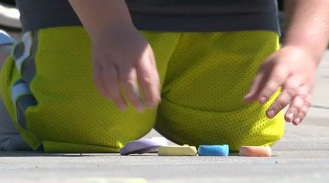 Child preparing to draw on sidewalk. Video stock 27950812