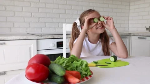 Child Preparing Green Salad in Kitchen, Girl Cutting Vegetables Healthy Meal Stock Footage 138987965