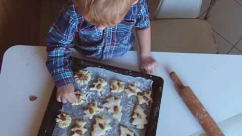 Child preparing homemade cookies on baking tray in kitchen. Stock Footage 331258668
