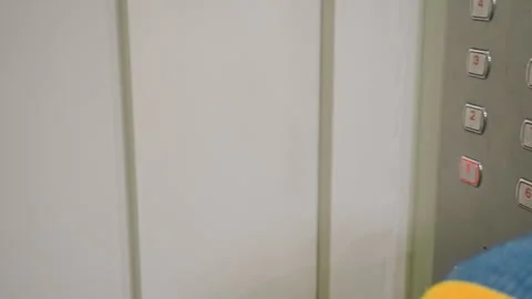 Child presses button. Curious child interacts with glowing elevator controls Stock Footage 337726179