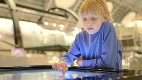 A child of primary school age visiting a science museum Stock Footage 261556595