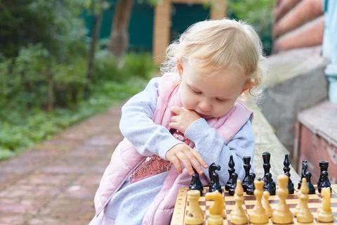 Child prodigy plays chess. The concept of development, training, education Stock Photos