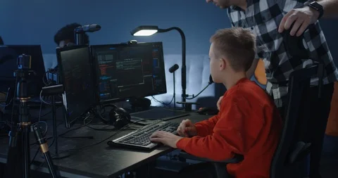 Child programmer getting instructions from colleague Stock-Footage 125174530