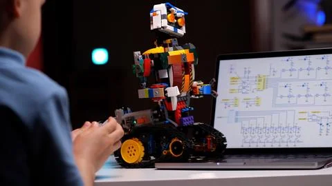 Child programming robot using laptop in high tech computer class Stock Photos