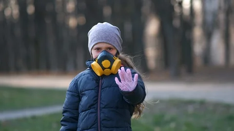Child in protective mask, face-guard to prevent breathing toxic air. Stock Footage 128020097