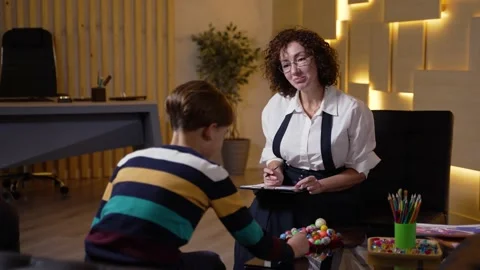 Child psychologist testing boy during counseling Stock Footage 190980008