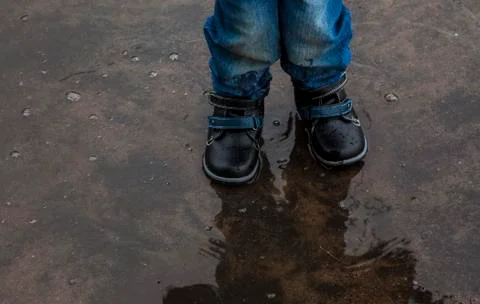 Child in the puddle Stock Photos