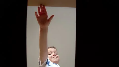 Child pull their hands into the box. Cute Happy kid, Overjoyed at the Surprise Stock Footage 168061961