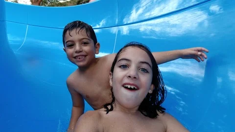 Child pulling down a water slide Stock Footage 119694167