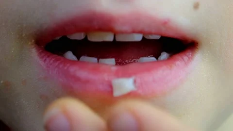 Child pulling a loose tooth on camera. Stock Footage 150329227