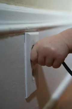 Child pulling plug Stock Photos