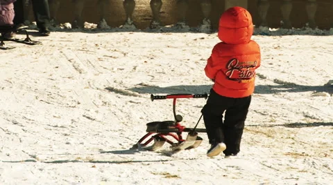 Child pulling sled Stock Footage 1042065