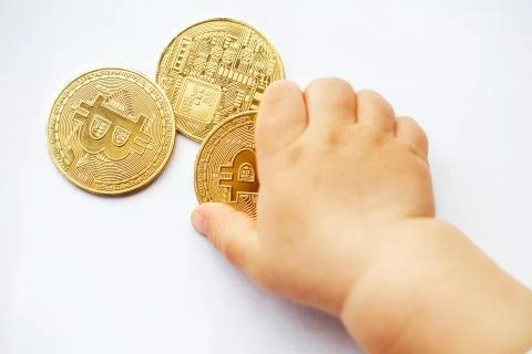 The child pulls hands to Bitcoin cryptocurrency coins. The future is decentra Stock Photos