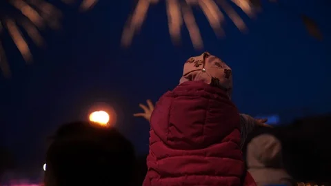 Child pulls hands to the exploding firework. Exploding firework Video stock 107919099