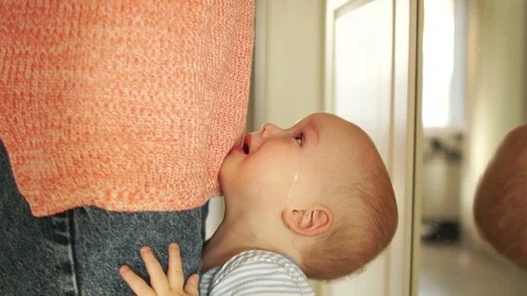 Child pulls his hands up to his mother. Asks to take him in his arms, a crying Stock Footage 121453615