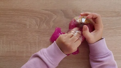 The child pulls the slime out of the jar Stock Footage 221337622