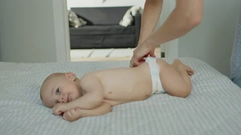The child is put on a diaper Stock Footage 143352949