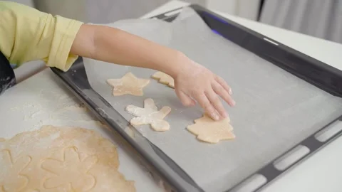 A child puts cookie dough on a baking sheet. Stock Footage 253434216