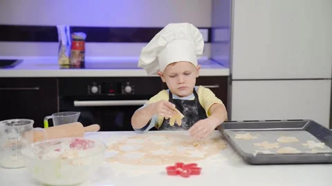 Child puts dough on a baking sheet Stock Footage 253434242