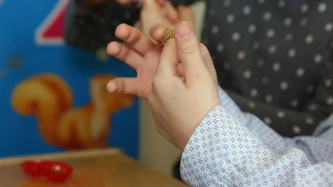 A child puts a gold ring on his finger. Spring. Close-up Stock Footage 129813214