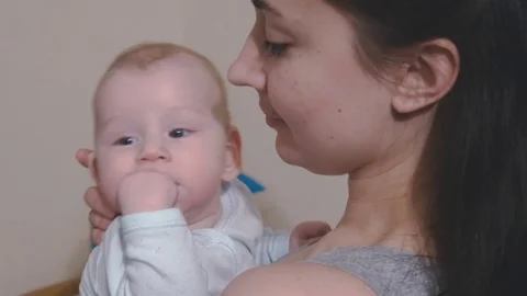 Child puts his hand in himself mouth and gnaws at her Stock Footage 80537166
