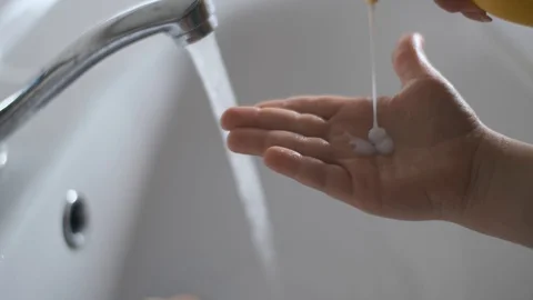 The child puts soap on his hands before washing them. Hygiene requirements Video stock 128177739
