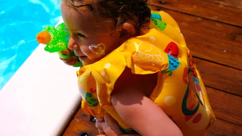 The child puts sunscreen on her face. Selective focus. Stock Footage 245696004