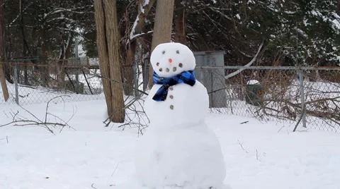 Child Putting a Hat on a Snowman 스톡 동영상 47975390