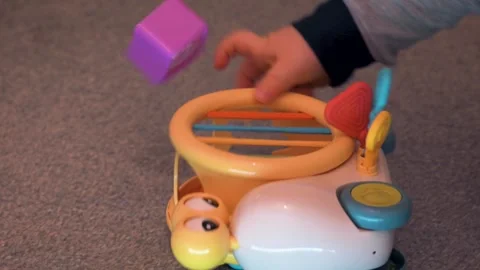 Child Putting Shape into Snail Sorter Toy Video stock 325767672